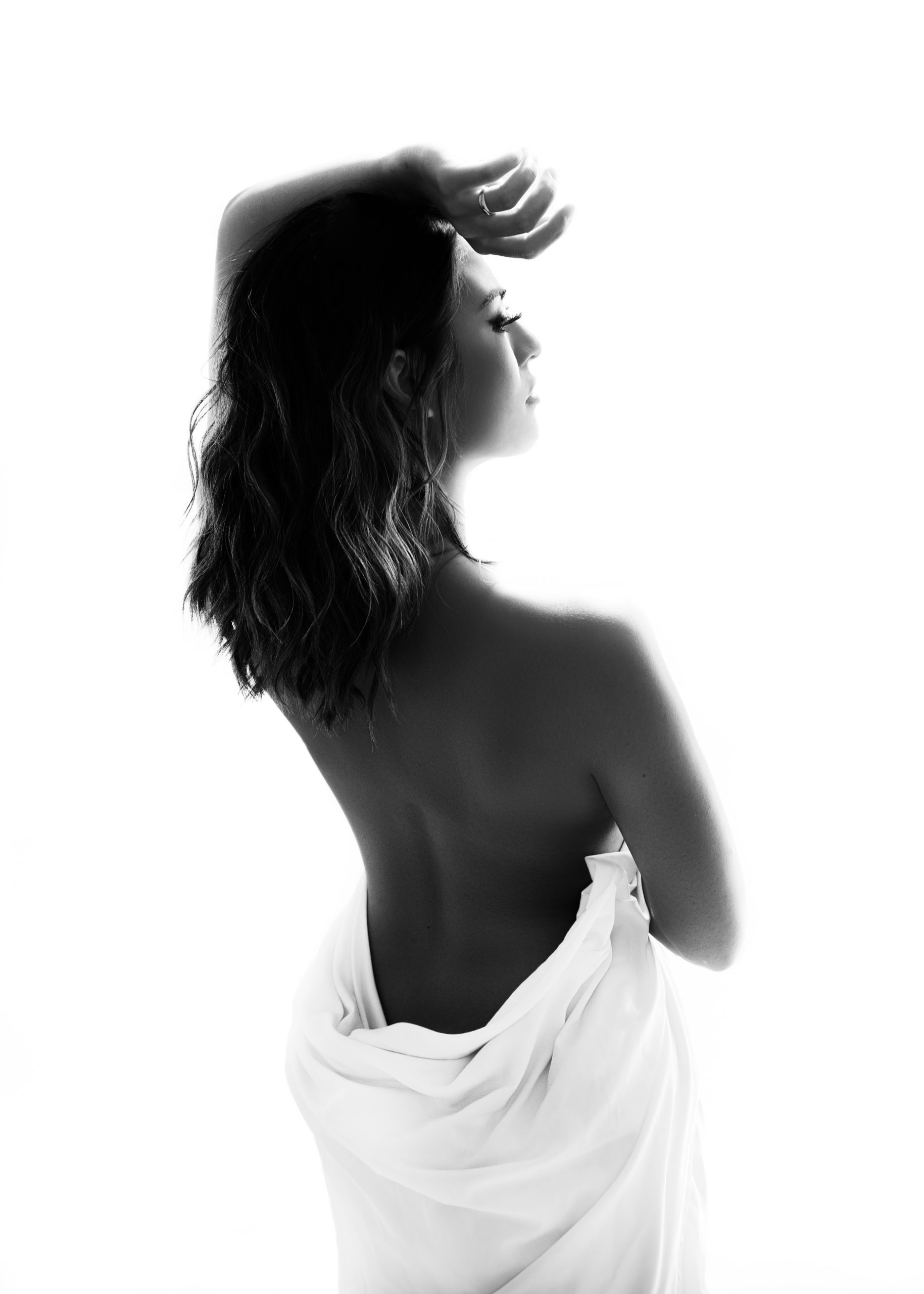 Tasteful nude boudoir Image of woman standing in a white sheet By Andrea Liora Studios in San Francisco