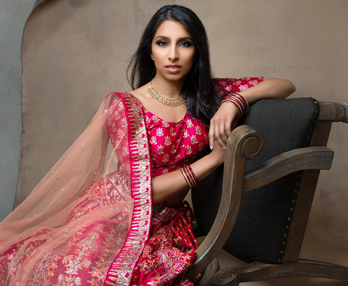 Glamor portrait of an Indian bride wearing a red traditional Indian dress by Andrea Liora Studios in San Francisco CA.