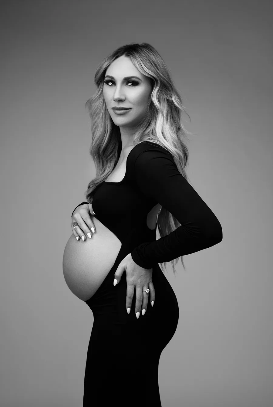 maternity portrait of a pregnant woman wearing a black dress with belly exposed taken by Andrea Liora Studios in San Francisco CA.