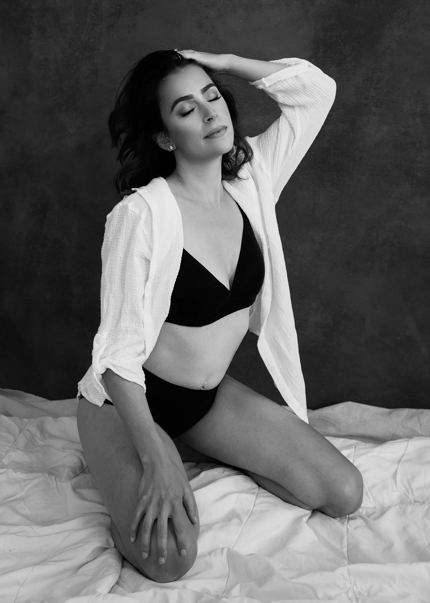 black and white boudoir and empowerment portrait of a woman wearing high waisted shorts and an oversized sweatshirt. Casual Boudoir photography by Andrea Liora Studios in San Francisco, CA.