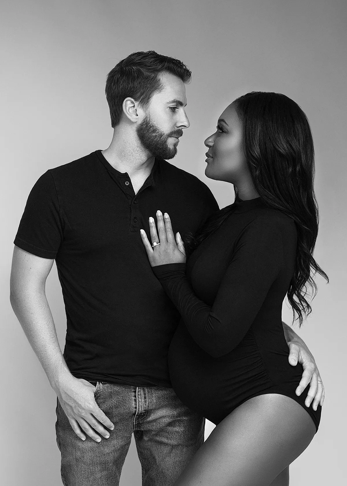 Black and white photo of a pregnant woman and her husband taken in studio. Maternity photography by Andrea Liora Studios in San Francisco Ca.